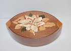 Wooden Magnolia  I have started to challenge myself a little more.  Getting a near perfect fit on a lid for a non-square box has its challenges.  The marquetry is supposed to be a magnolia.  What do you think?